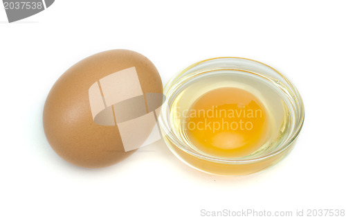 Image of One whole egg and another broken in half raw egg
