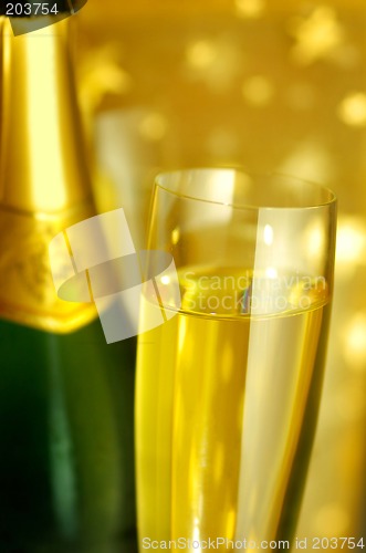 Image of Flute glass and a bottle of Champagne