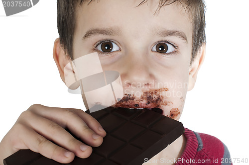 Image of Smiling little boy eating chocolate