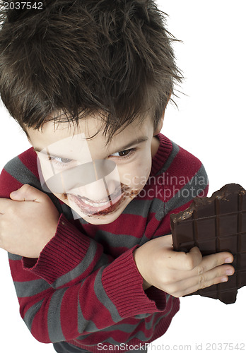 Image of Smiling little boy eating chocolate