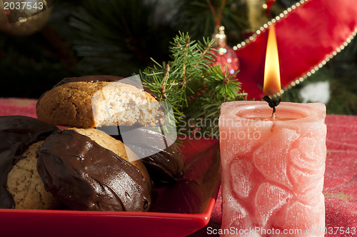 Image of Christmas sweets and candle on the table