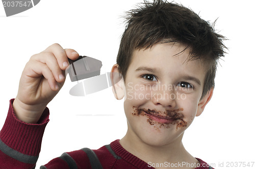 Image of Smiling little boy eating chocolate