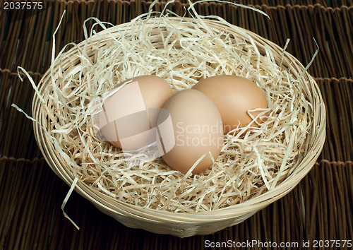 Image of Raw eggs in a wicker basket