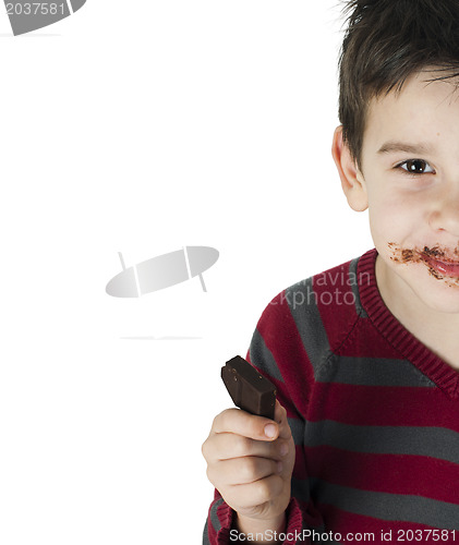 Image of Smiling little boy eating chocolate