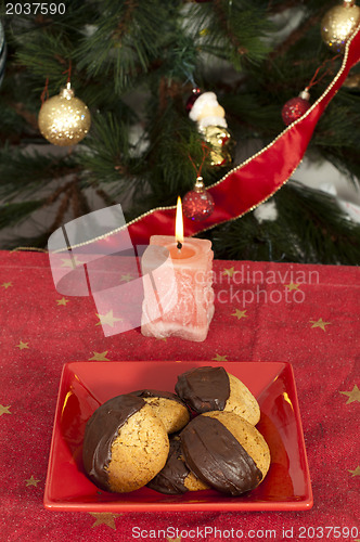 Image of Christmas sweets and candle on the table