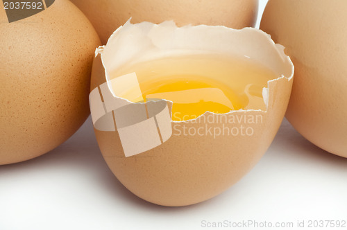 Image of Tree whole eggs and another broken in half raw egg