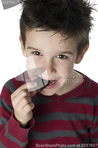 Image of Smiling kid eating chocolate