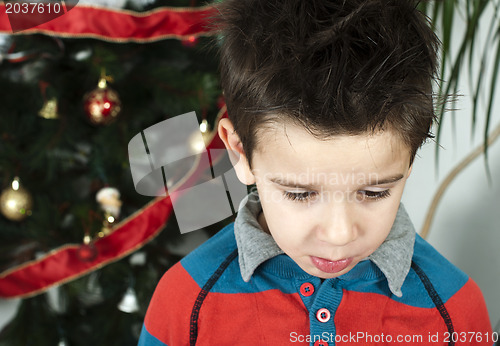 Image of Unhappy little boy on christmass