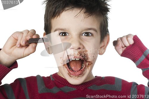 Image of Smiling little boy eating chocolate