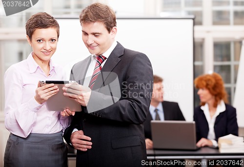 Image of business team with tablet cellphone computer