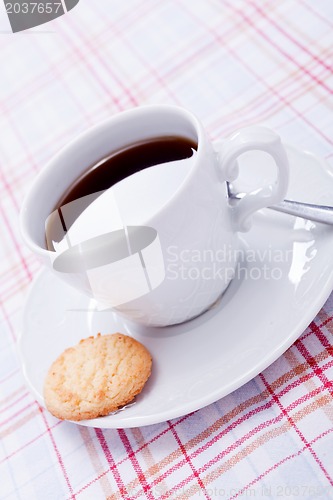 Image of dark coffee in cup homemade cookie on table
