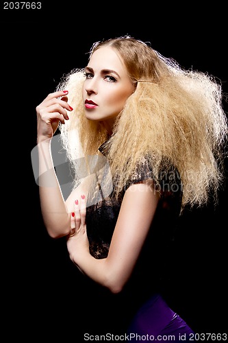 Image of young pretty blonde woman with big hair fashion