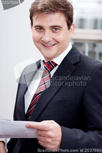 Image of business man with tie and suit with documents 