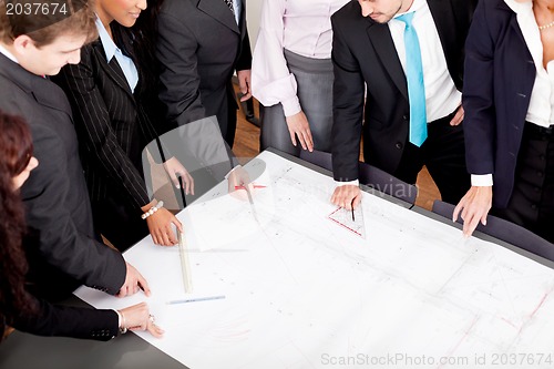 Image of business people discussing architecture plan sketch 