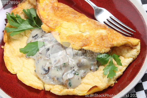 Image of Souffle omelet with mushrooms in sauce