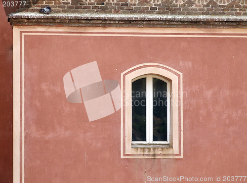 Image of Single window on a red wall