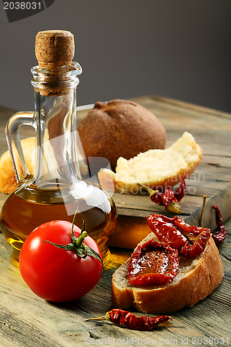 Image of Sun dried tomatoes, white bread and olive oil.