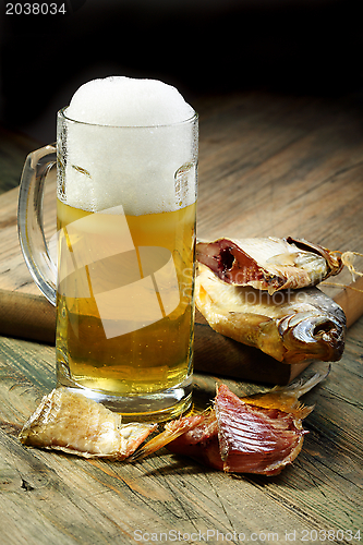 Image of Salted fish and a full glass of beer.