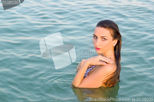 Image of nice wet young woman in the water