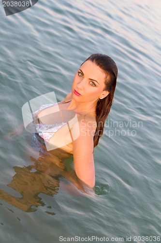 Image of beautiful wet young woman in the water