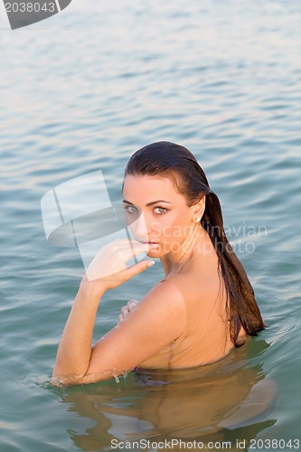 Image of attractive wet young woman in the water