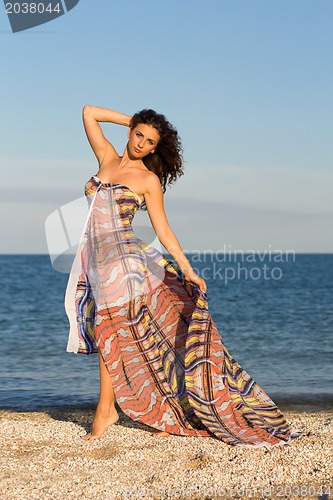 Image of Charming young woman in long dress