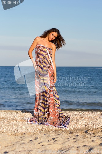 Image of Cute young woman in long dress