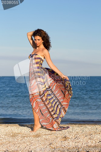 Image of Attractive young woman in long dress