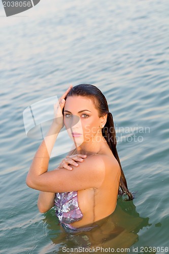 Image of cute wet young woman in the water