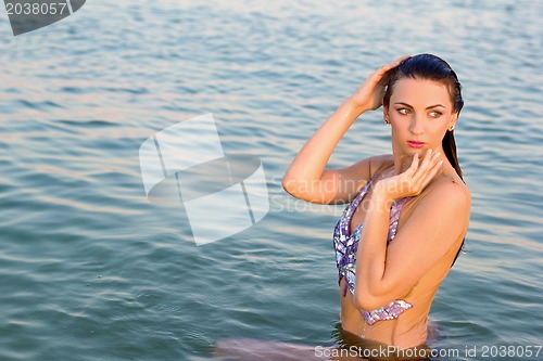 Image of cute young woman in the water