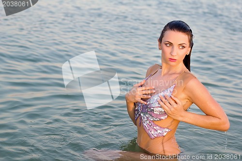 Image of nice young woman in the water