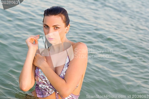 Image of lovely wet young woman in the water