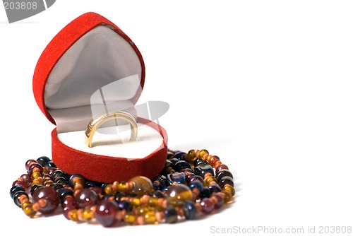 Image of Gold ring in a red velvet box in the form of heart