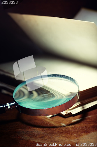 Image of Old book and magnifier