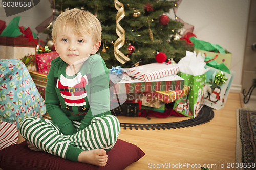 Image of Young Boy Enjoying Christmas Morning Near The Tree