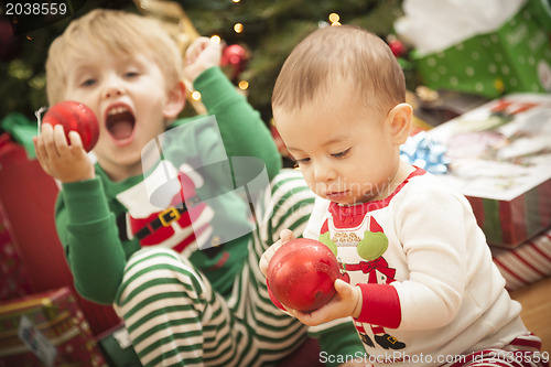 Image of Mixed Race Baby and Young Boy Enjoying Christmas Morning Near Th