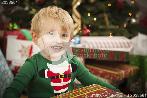 Image of Young Boy Enjoying Christmas Morning Near The Tree