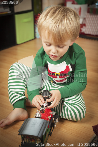 Image of Young Boy Enjoying Christmas Morning Near The Tree