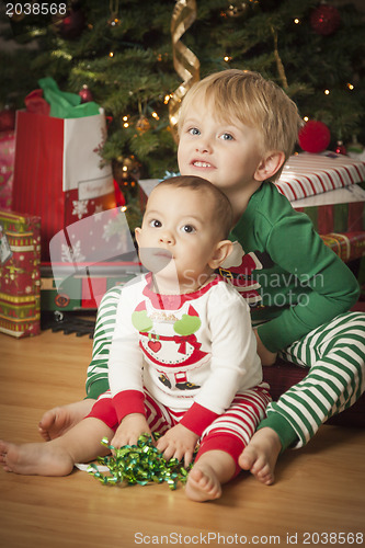 Image of Mixed Race Baby and Young Boy Enjoying Christmas Morning Near Th