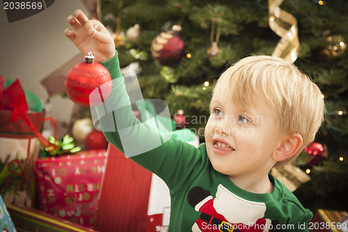 Image of Young Boy Enjoying Christmas Morning Near The Tree