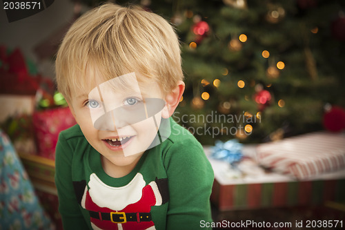 Image of Young Boy Enjoying Christmas Morning Near The Tree