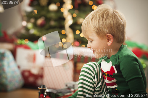 Image of Young Boy Enjoying Christmas Morning Near The Tree