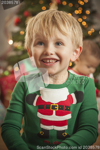 Image of Young Boy Enjoying Christmas Morning Near The Tree