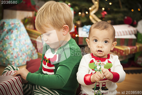 Image of Mixed Race Baby and Young Boy Enjoying Christmas Morning Near Th