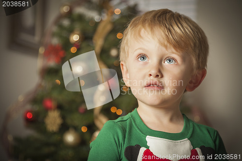 Image of Young Boy Enjoying Christmas Morning Near The Tree