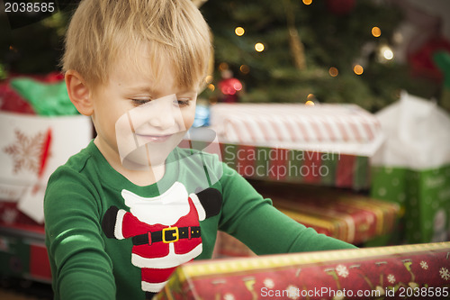 Image of Young Boy Enjoying Christmas Morning Near The Tree