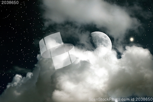 Image of Moon on a background of the star sky and clouds