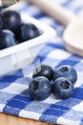 Image of blueberries on checkered tablecloth