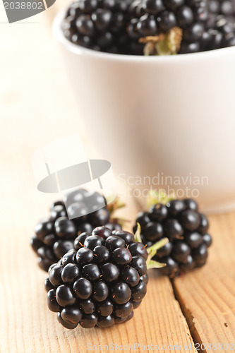 Image of blackberries on wooden background