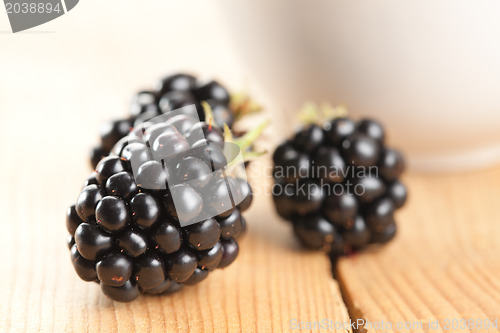 Image of blackberries on wooden background